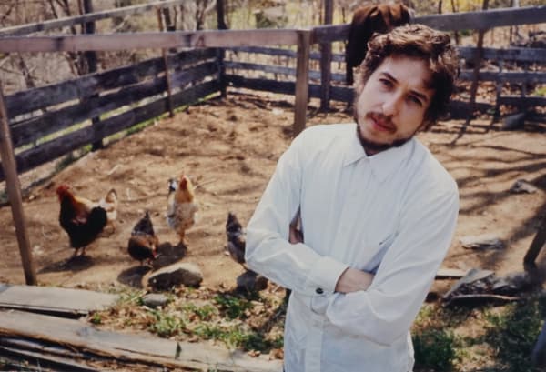 John Cohen, Bob Dylan in Putnam Valley (in chicken yard with arms crossed), 1970 (printed 2023)