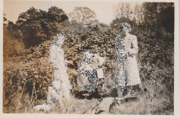 John Latour, Two women in coats standing on either side of an elderly woman in a wheelchair. A young girl seated to the woman on the left inspects an unknown object, 2020