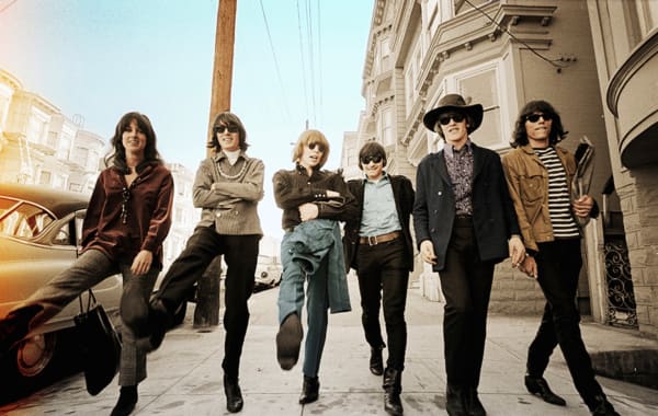 Jim Marshall photograph of Jefferson Airplane Haight Ashbury walking with blue sky