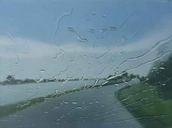 A road leading to a blue sky horizon with a grassy bank on its right and a river on its left, seen through a glass screen with water droplets scattered across it. By artist Esther Nienhuis. oil on linen 2024, Rebecca Hossack Art Gallery London, Contemporary art