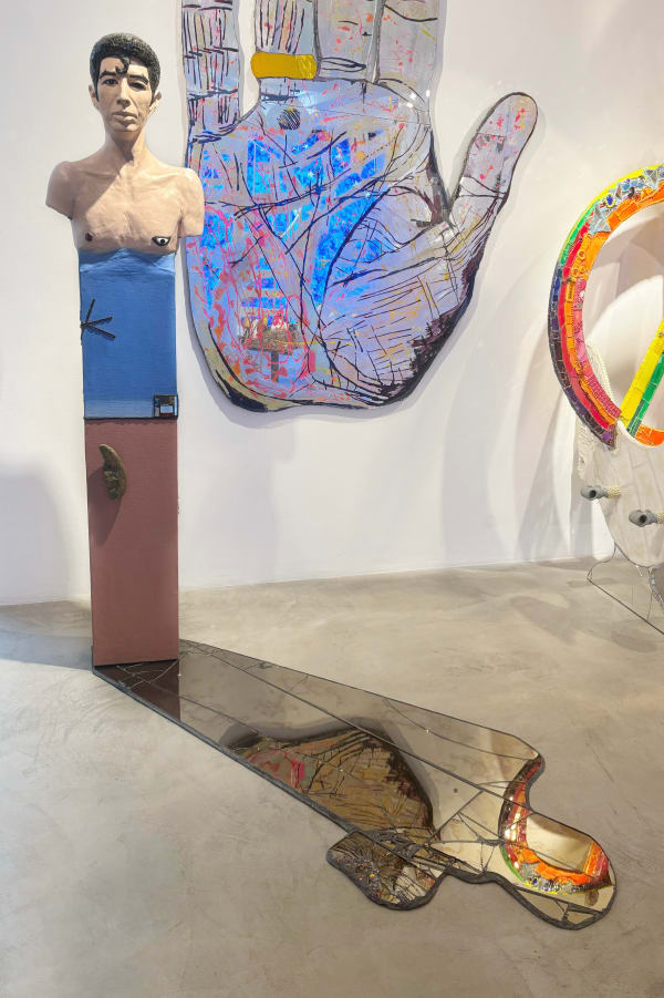 Mixed-media sculpture by artist Andrew Logan, created in tribute to his friend, Duggie Fields. Composed of a portrait bust and mirrored reflection.