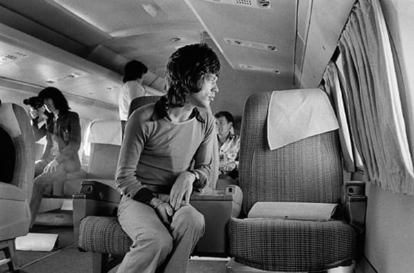 Jim Marshall, Mick Jagger sitting on a plane