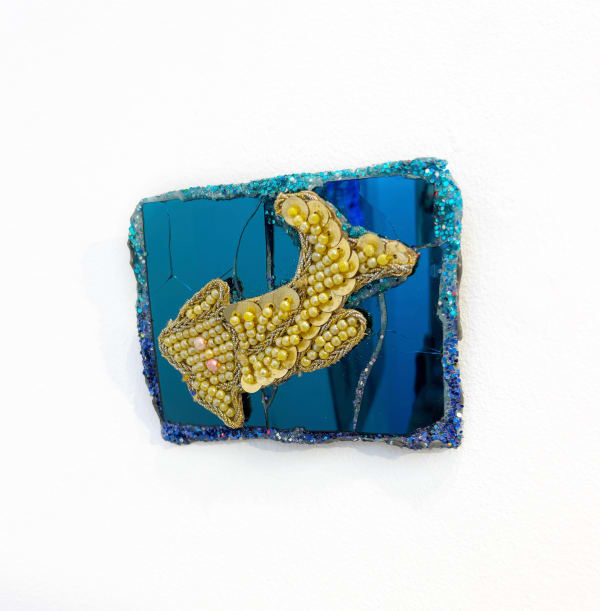 Eccentric British sculptor Andrew Logan's presents a blue and gold mirrored fish.