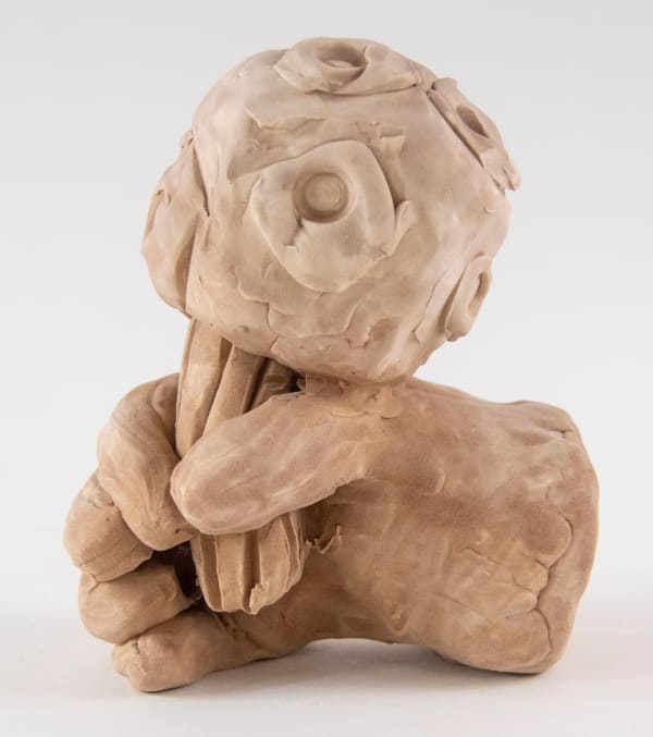 A sculpture of a hand holding a geoduck by artist Reniel Del Rosario