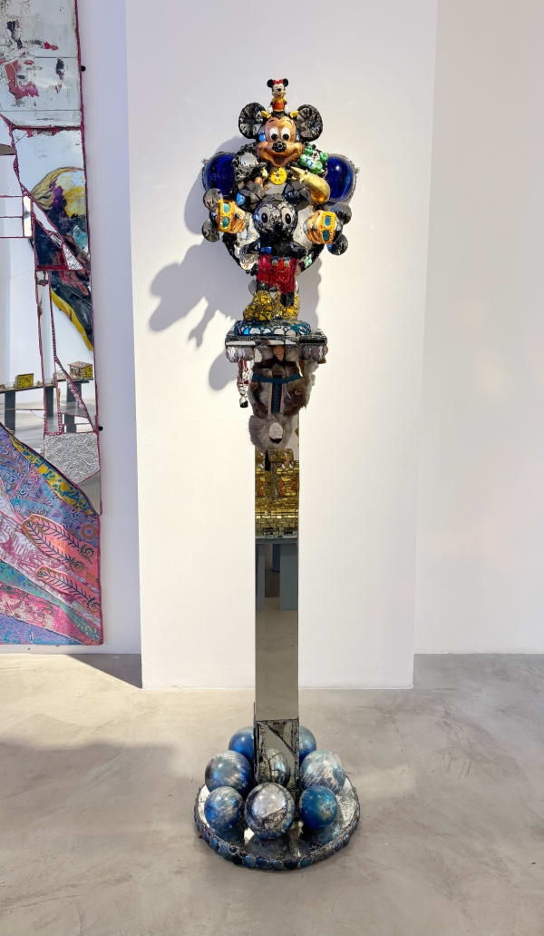 Eccentric sculpture created by visionary British artist Andrew Logan, featuring Mickey Mouse and other playful ceramic characters.