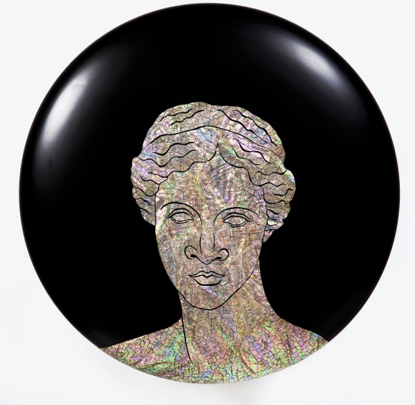 A woman's head facing forward with multi-colored rainbow skin and hair.