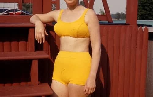 ENLARGEMENT REPRINT Vernacular, Untitled, [Exterior back yard, woman head cropped off wearing yellow bathing costume]