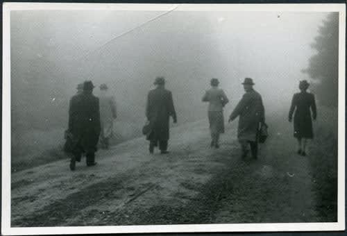 ENLARGEMENT REPRINT Vernacular, Untitled, [Exterior wooded landscape, rural road, misty figures walk away from the camera, one man looking back. All wearing hats]