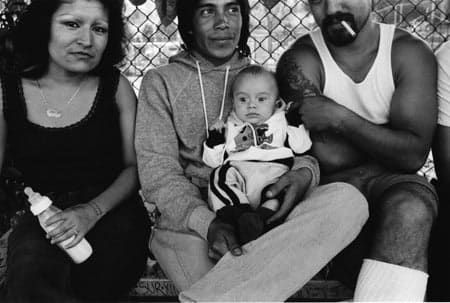 Graciela Iturbide, Cholos in the park, where different gangs meet togetherWhite fence, East L.A., 1986