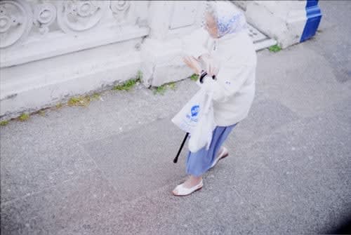 Rinko Kawauchi, Untitled, [woman with shopping bag and cane]From the series "Murmuration", 2010
