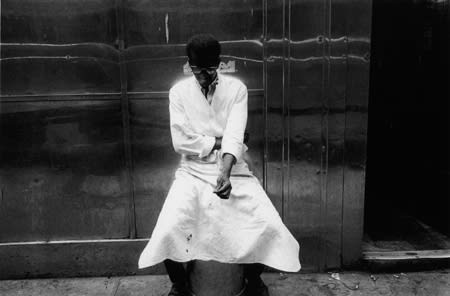 Bruce Davidson, Untitled [glowing man in front of metal wall, two stripes of light], New York City, A Time of Change, 1962