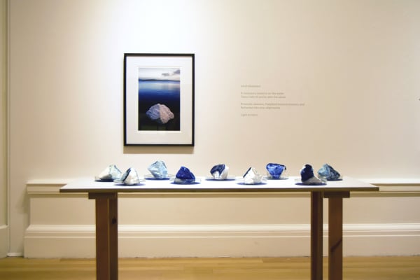 Anne Bevan RSA (Elect) + Mark Edmonds all manner of singular forms (Erratic 1-9), 2024 Installation incorporating wooden table, cast plaster with ink and watercolour, glass dishes 80 x 180 x 80 cm