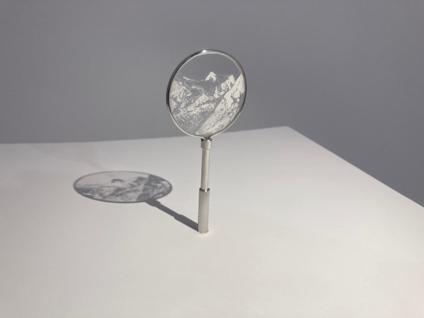 Sarah Casey Ice Watch (Tsanfleuron), 2025 Glacial flour on glass Drawing: 4 x 4 cm Mounted in lens holder: 10 x 4 cm Plinth: 110 x 35 x 35 cm