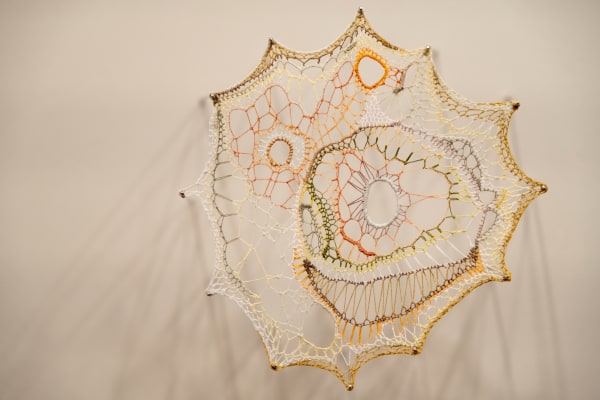 Jillian Lee Adamson Metaphorical Cell No. 25: His Milquetoast Excuses and Petechial Hemorrhage Freckles Are No More, 2025 Single strands of stranded embroidery floss suspended on sewing needles 15.5 x 14.5 cm
