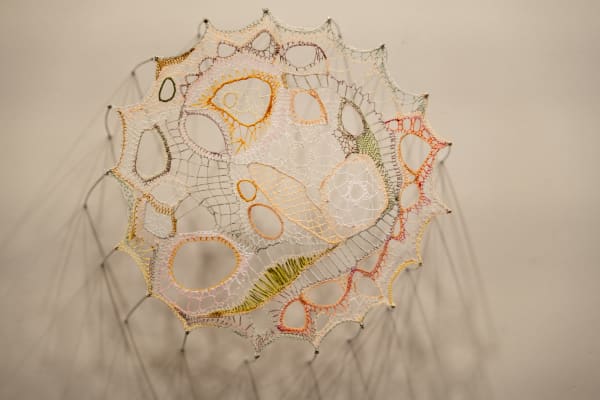 Jillian Lee Adamson Metaphorical Cell No. 21: Tamiflu TukTuk, 2025 Single strands of stranded embroidery floss suspended on sewing needles 22 x 20.5 cm