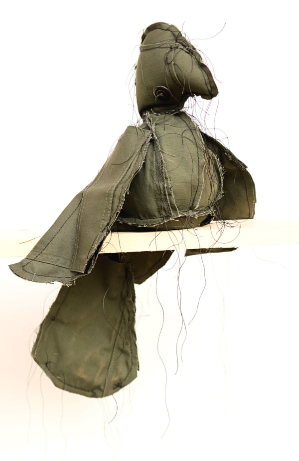 Margarita Cabrera Pepita Para El Loro Para Que Hable o Calle #5 (A Nugget for the Parrot so that it Speaks or Stays Quiet), 2019 Mixed media - Border Patrol uniform fabric, string, mimicry audio device 10 x 11 x 6" 25.4 x 27.9 x 15.2 cm