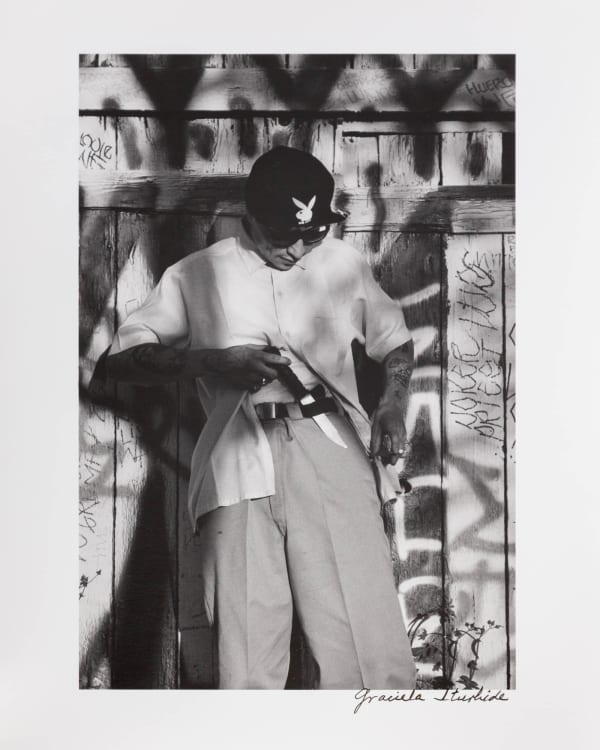 Graciela Iturbide Cholo Harpys, White Fence, East Los Ángeles, 1986 Silver Gelatin Print 10 x 8 in 25.4 x 20.3 cm