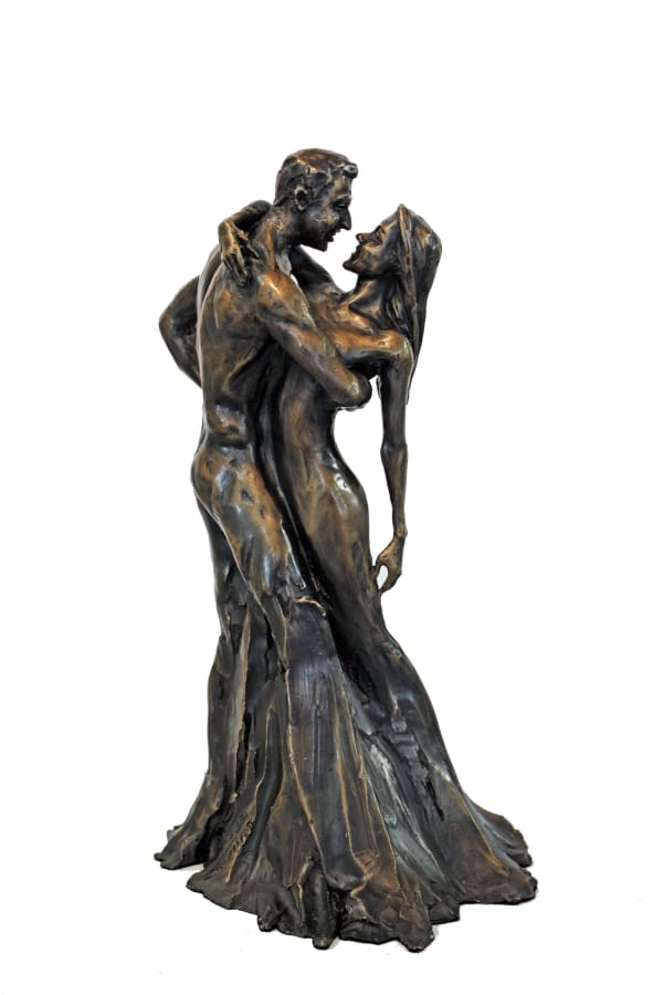 A bronze statuette titled Lovers, depicting a couple in an intimate embrace. The male figure gently holds the female figure close as they share a tender, loving gaze. Their flowing garments merge, forming a cohesive and elegant base for the sculpture.
