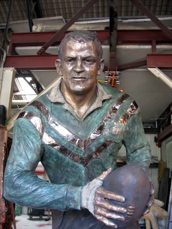 Detail view of the finely crafted facial features and uniform of Bronze statue of rugby league legend Peter 'Pedro' Gallagher