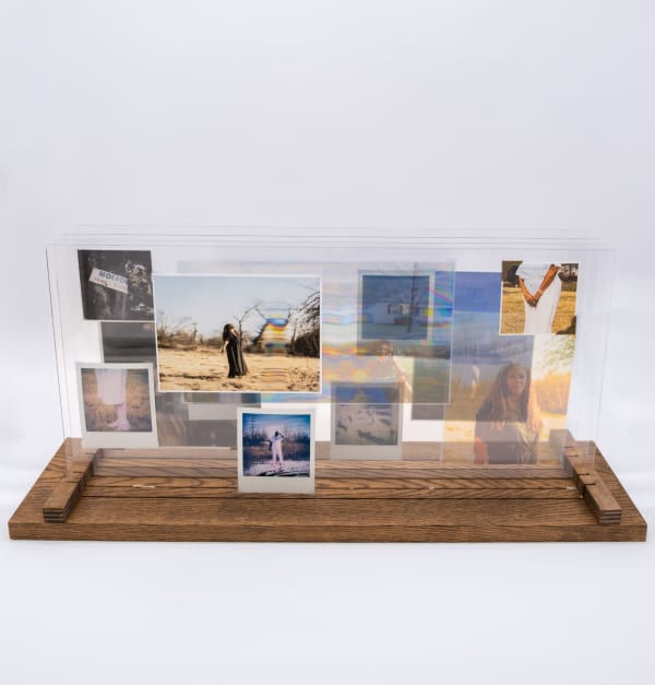 A sculpture by Shabez Jamal consisting of photographs suspended and collaged against pieces of plexiglass.