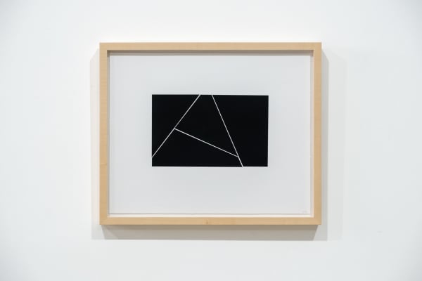 A framed black and white abstract screen print by Ian Gouldstone. A black rectangle is divided into multiple sections by thin white lines.