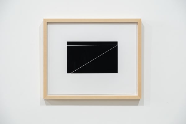 A framed black and white abstract screen print by Ian Gouldstone. A black rectangle is divided into multiple sections by thin white lines.