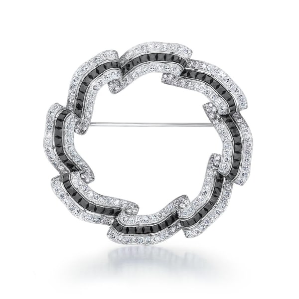 An Art Deco Onyx and Diamond Circle Brooch, c. 1925