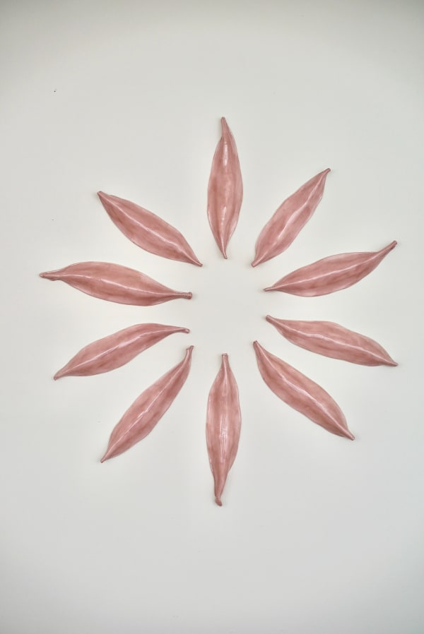 Pink Ceramic petals that can be arranged in multiple ways by slate gray gallery artist Angela Okajima-Kempinas