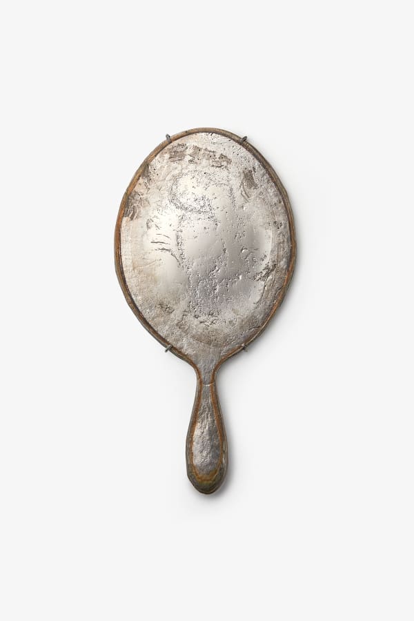 Adi Toch Large tall oval hand mirror (Cloudy) , 2023 Speculum metal alloy (white bronze), Oxidised bronze mount 34 H x 17 W x 2 D cm 13.3 H x 6.6 W x 0.7 D in