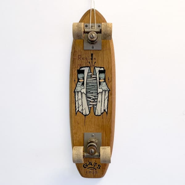 Vintage wood skateboard with a painted image of a mask-like face torn in half, revealing rope/tentacle like strands holding the halves together.