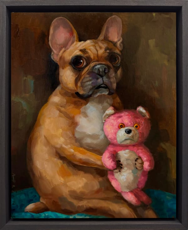 dog holding a pink stuffed teddy bear