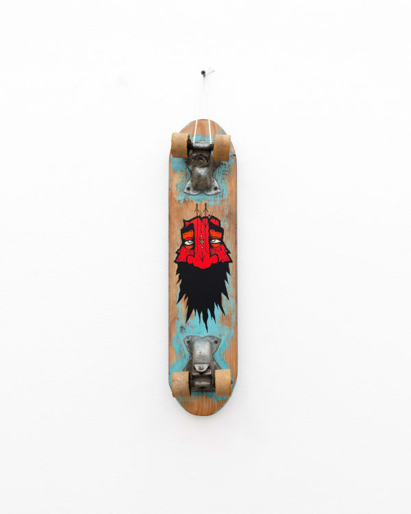 Vintage wooden skateboard with GATS character with a red face and big black beard painted on the bottom of it