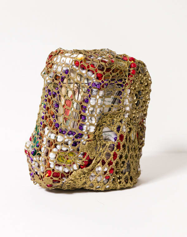 crocheted net covering found objects