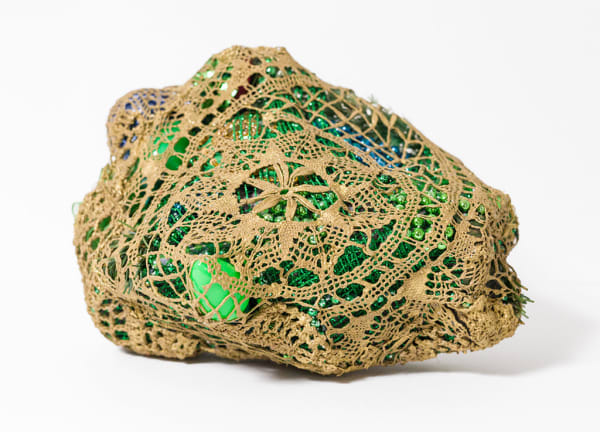 crocheted net covering found objects