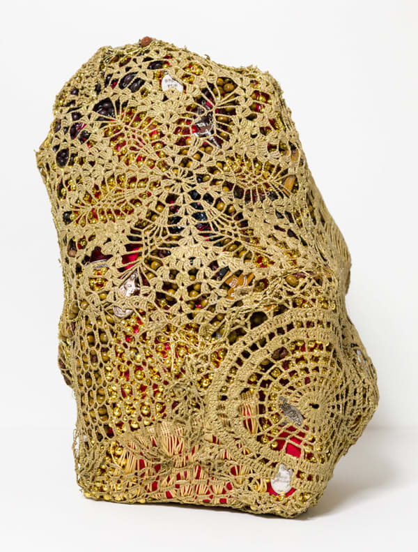 crocheted net covering found objects