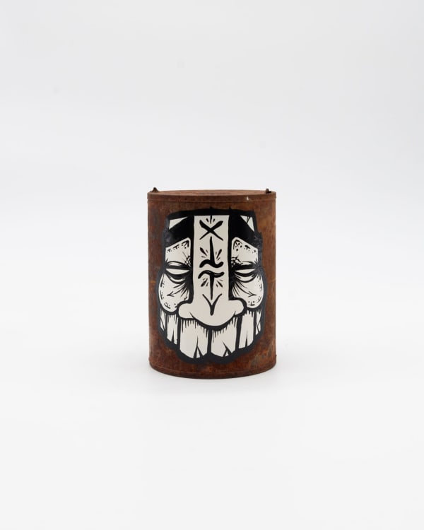 Rusted can with GATS character painted in black and white