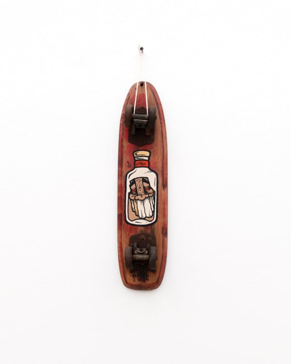 Brown wooden vintage skateboard with GATS character in a glass jar painted on the bottom of it
