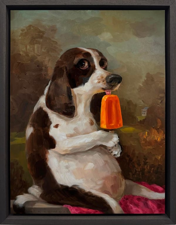 dog licking an orange popsicle