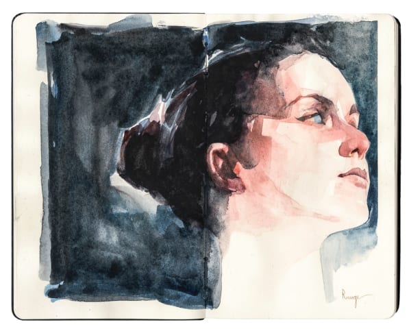 Portrait of a woman with her face turned to the side with dark hair and light skin on a black background