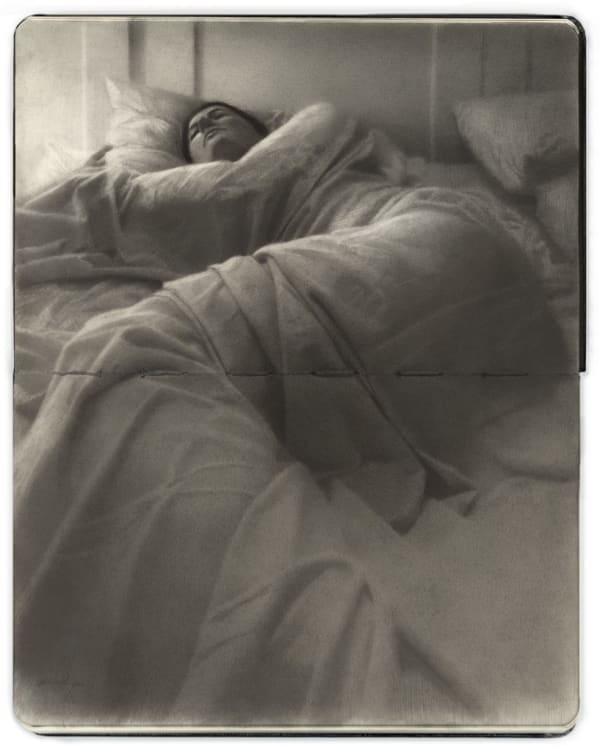 Openface Moleskine notebook with a graphite and charcoal drawing depitcting a woman laying in bed by artist Zachary Oldenkamp