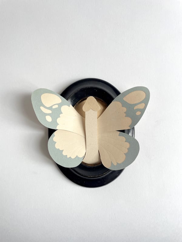 paper sculpture of a penis with butterfly wings