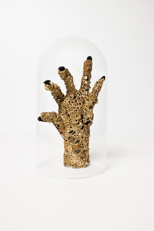 crocheted thread sculpture of a hand