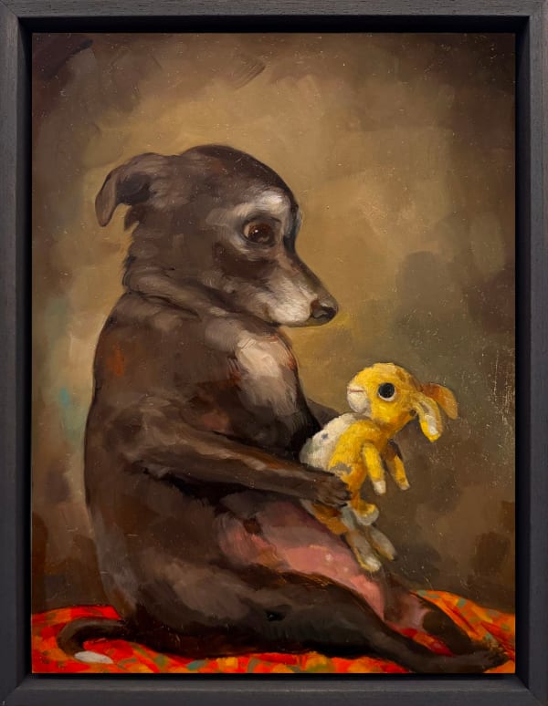 dog holding a stuffed bunny