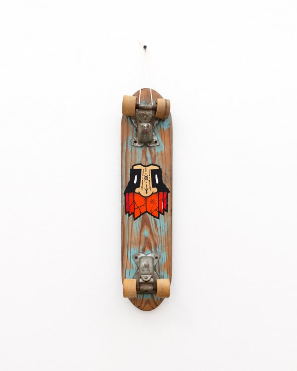 Wooden vintage skateboard with GATS character with an orange beard painted on it