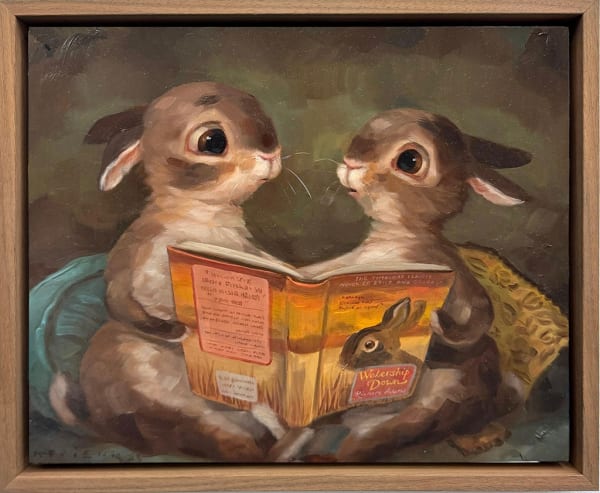 A painting of two brown bunnies sitting and holding a yellow book with a bunny on the cover.