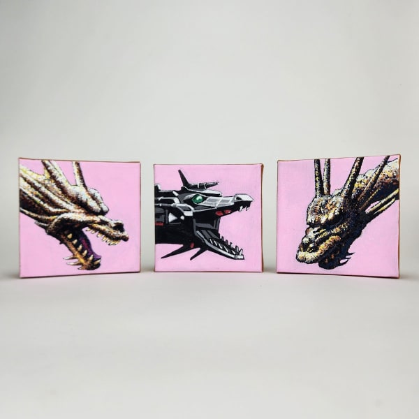 Three small paintings of dragon heads on pink backgrounds