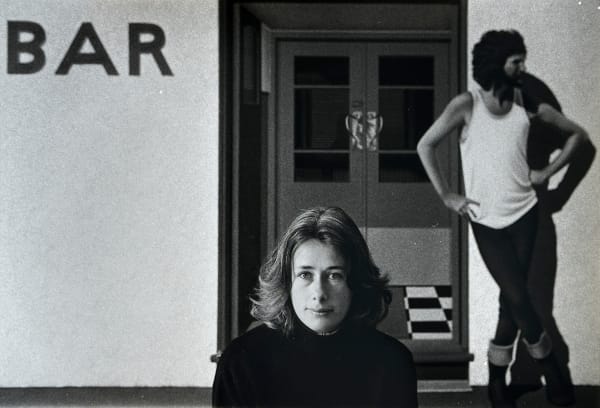 Robin Morrison, Portrait of Robin White sitting in front of her painting “Sam Hunt at the Portobello Pub”, 1978