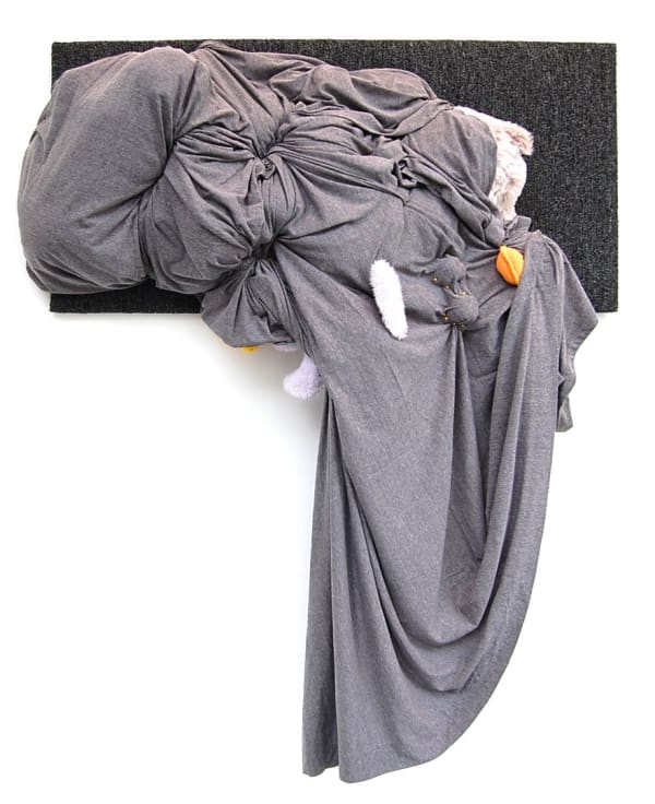 Wall sculpture with draped gray fabric