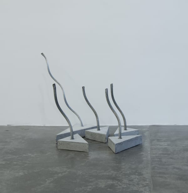 Various shaped cement slabs with wire sticking out