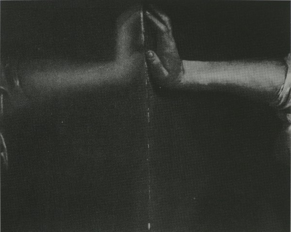 Black and white photograph of two hands touching palm to palm